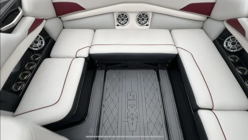Slide: The Image of 2018 Axis Boats A22 interior with white seating and built-in speakers. - 13