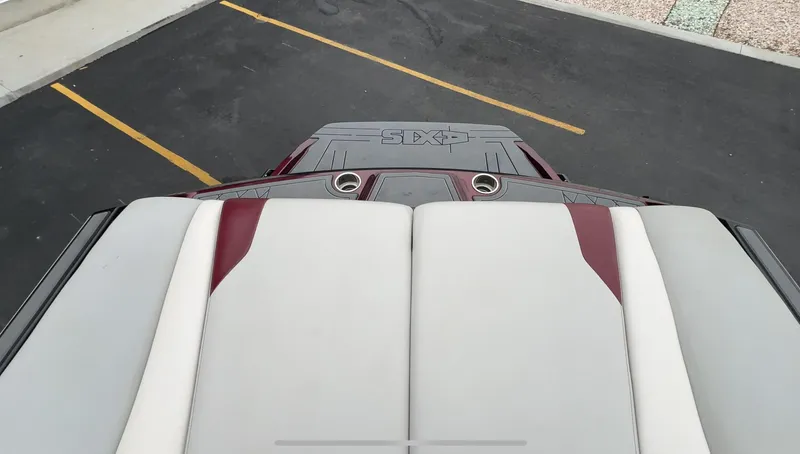 Slide: The Image of 2018 Axis Boats A22 rear seating and deck, featuring gray and maroon upholstery. - 14