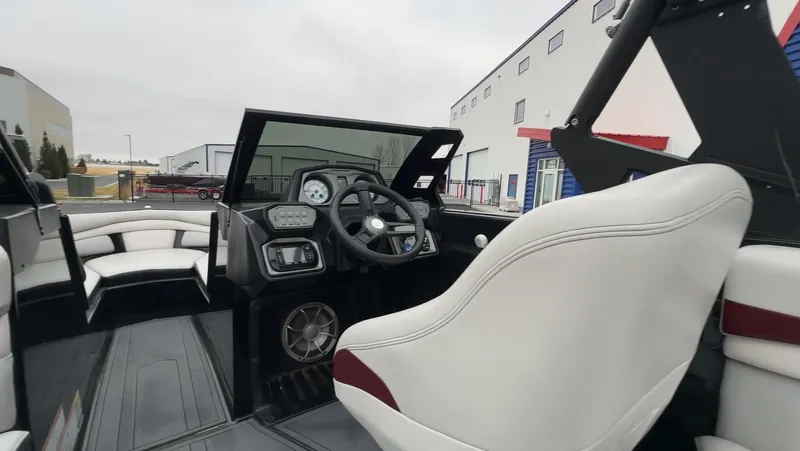 Slide: The Image of 2018 Axis Boats A22 interior with steering wheel and seating, showcasing modern design. - 15