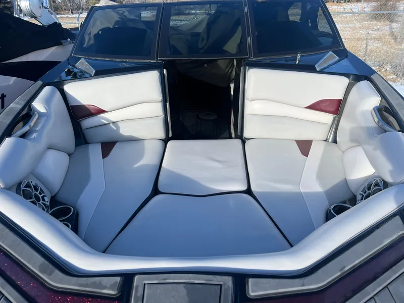 Slide: The Image of 2018 Axis Boats A22 interior with white and maroon seating, featuring built-in speakers. - 16