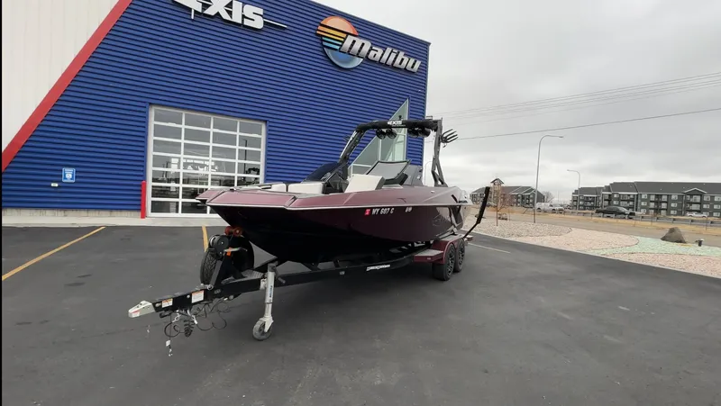 Slide: The Image of 2018 Axis Boats A22 on trailer outside dealership, overcast day. - 3