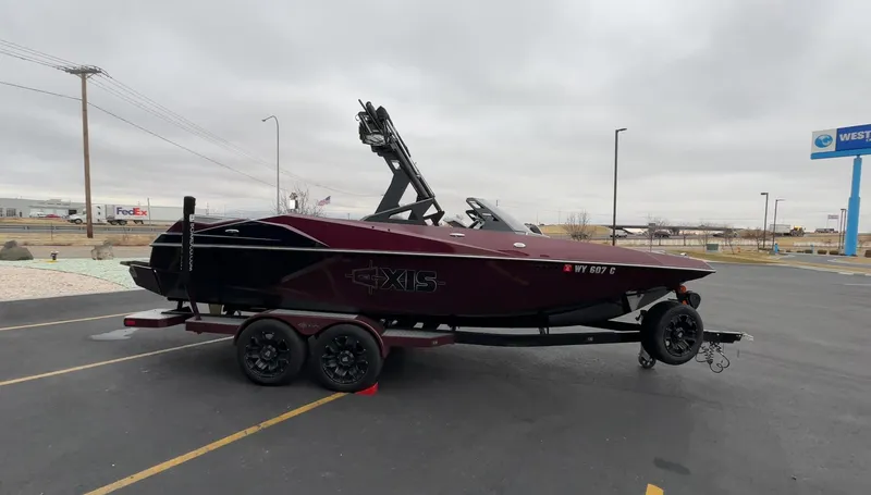 Slide: The Image of 2018 Axis Boats A22 on trailer in parking lot, overcast sky. - 6