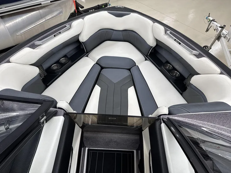 Slide: The Image of 2016 Malibu 25 LSV boat interior with sleek seating and cup holders. - 10