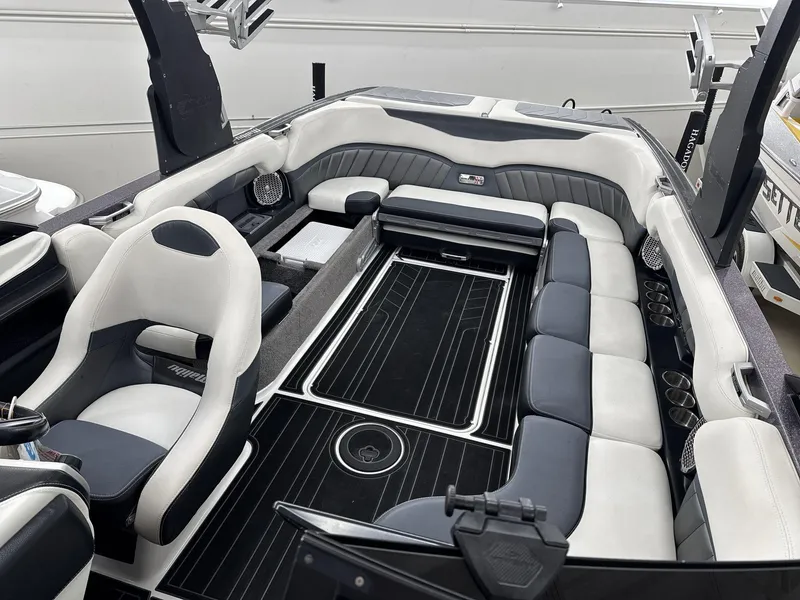 Slide: The Image of 2016 Malibu 25 LSV boat interior with sleek seating and modern design. - 11