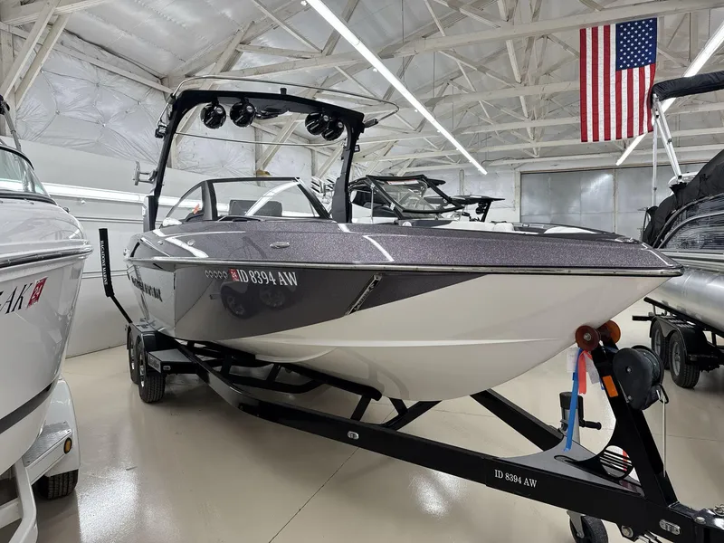 Slide: The Image of 2016 Malibu 25 LSV boat in showroom with American flag. - 3