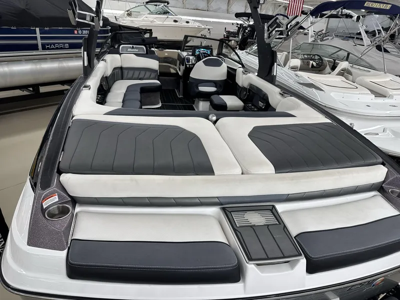 Slide: The Image of 2016 Malibu 25 LSV boat interior with sleek black and white seating. - 8