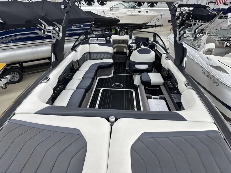 Slide: The Image of 2016 Malibu 25 LSV boat interior with sleek seating and modern design. - 9