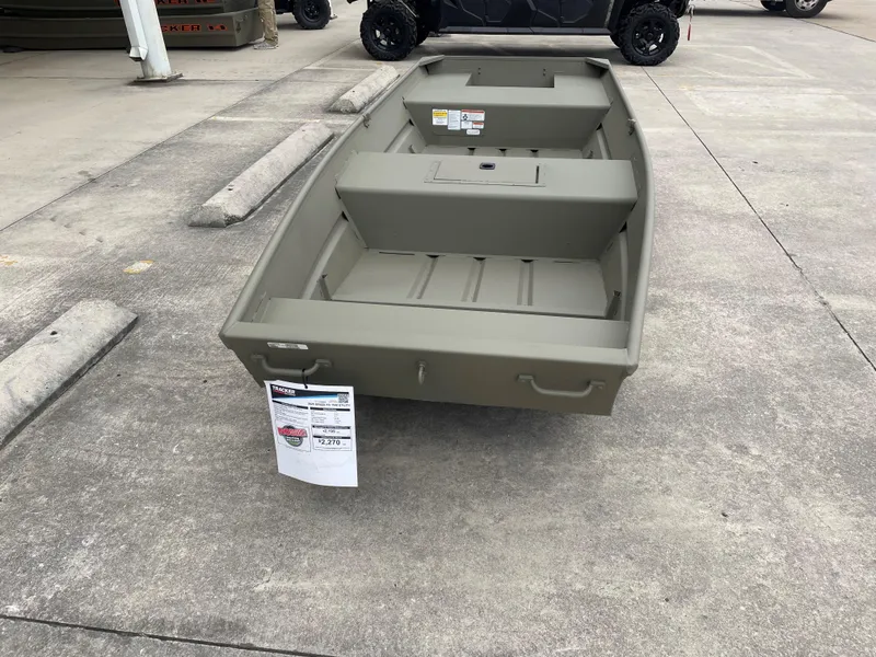 Slide: The Image of 2025 Tracker Grizzly 1542 Utility boat on concrete lot, front view. - 2