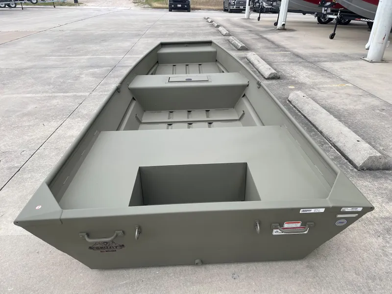 Slide: The Image of 2025 Tracker Grizzly 1542 Utility boat in a parking lot. - 5