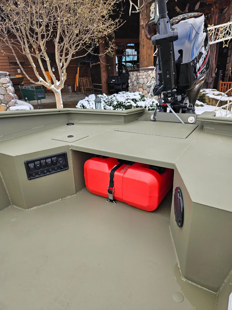 Slide: The Image of 2025 Tracker Grizzly 1650 T Prairie Wings Edition boat interior with red fuel tank. - 4