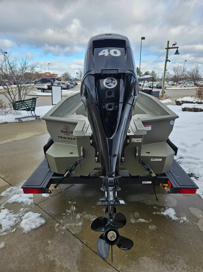 Slide: The Image of 2025 Tracker Grizzly 1650 T Prairie Wings Edition boat with 40 HP motor in snowy setting. - 6