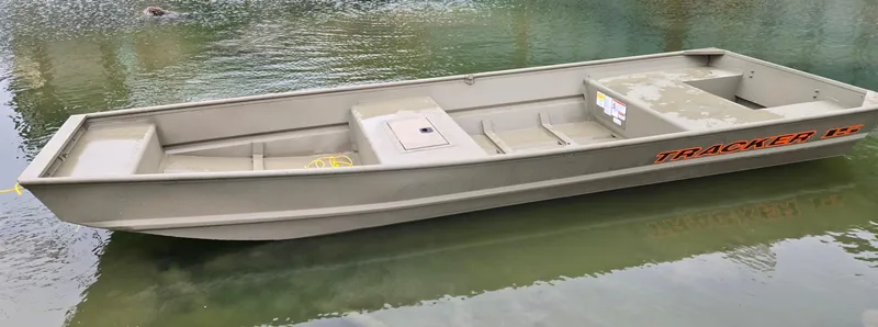 Slide: The Image of 2025 Tracker Grizzly 1542 Utility boat on calm water. - 2