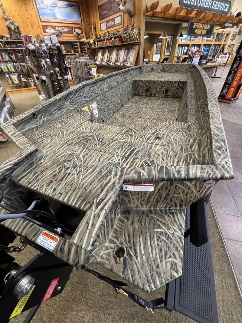 Slide: The Image of 2025 Tracker Grizzly 1650 T Prairie Wings Edition boat with camouflage design in showroom. - 10