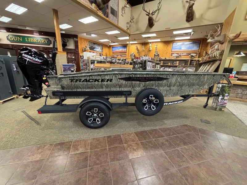 Slide: The Image of 2025 Tracker Grizzly 1650 T Prairie Wings Edition boat in showroom display. - 11