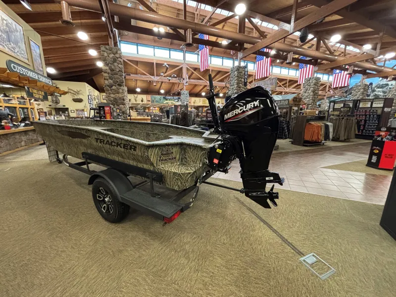 Slide: The Image of 2025 Tracker Grizzly 1650 T Prairie Wings Edition boat displayed indoors. - 5
