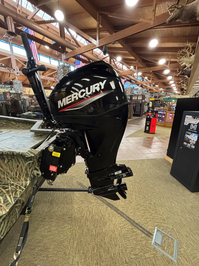 Slide: The Image of 2025 Tracker Grizzly 1650 T Prairie Wings Edition with Mercury outboard motor in showroom. - 7