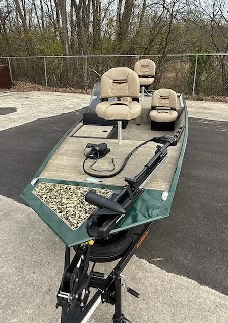 Slide: The Image of 2025 Tracker Bass Tracker Classic Limited fishing boat with seating and trolling motor. - 2