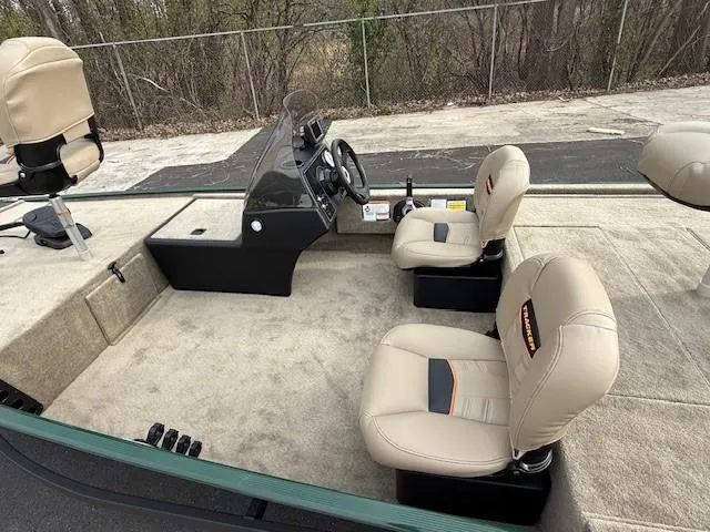 Slide: The Image of 2025 Tracker Bass Tracker Classic Limited boat interior with beige seats and steering console. - 3