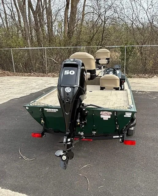 Slide: The Image of 2025 Tracker Bass Tracker Classic Limited boat with 50 HP motor, parked outdoors. - 4