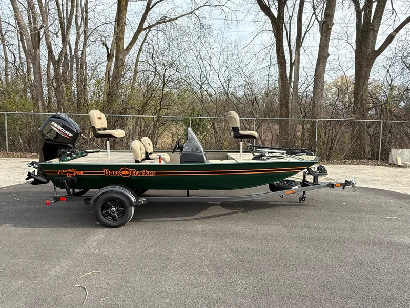 Slide: The Image of 2025 Tracker Bass Tracker Classic Limited boat on trailer, parked outdoors. - 44