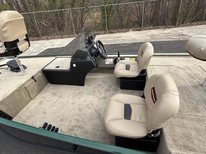 Slide: The Image of 2025 Tracker Bass Tracker Classic Limited boat interior with beige seats and steering console. - 48