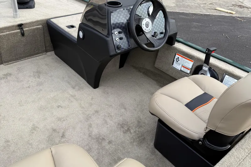 Slide: The Image of 2025 Tracker Bass Tracker Classic Limited boat interior with steering wheel and seating. - 49