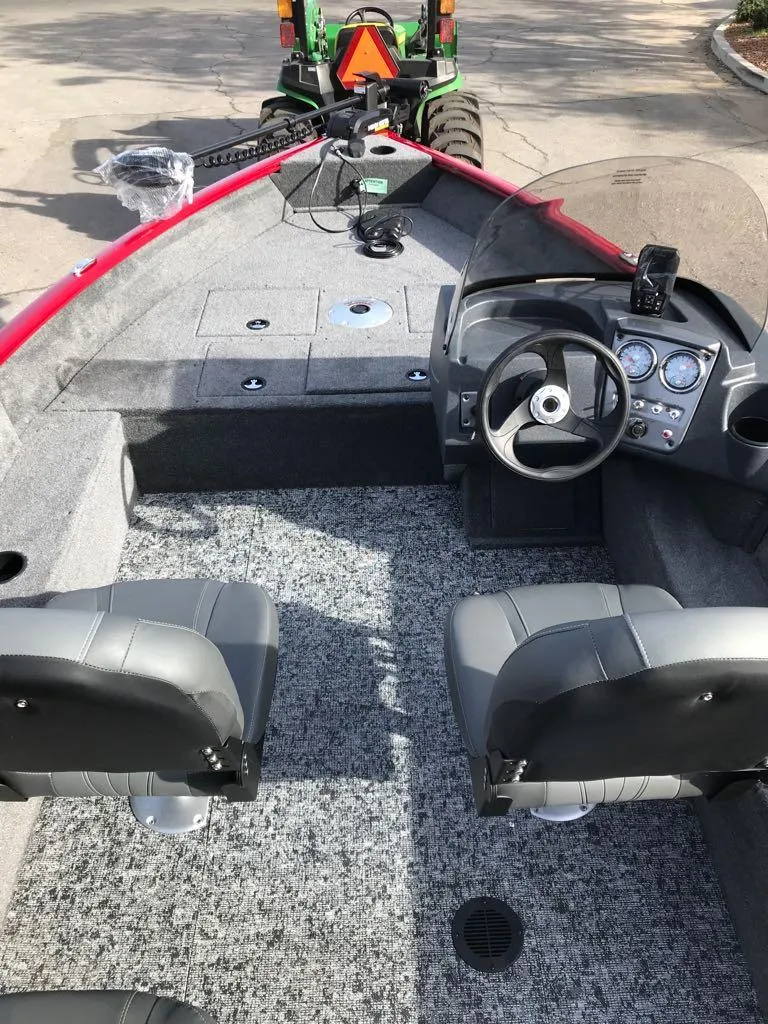 Slide: The Image of 2025 Tracker Pro Guide V-16 SC boat interior with steering wheel and seating. - 11