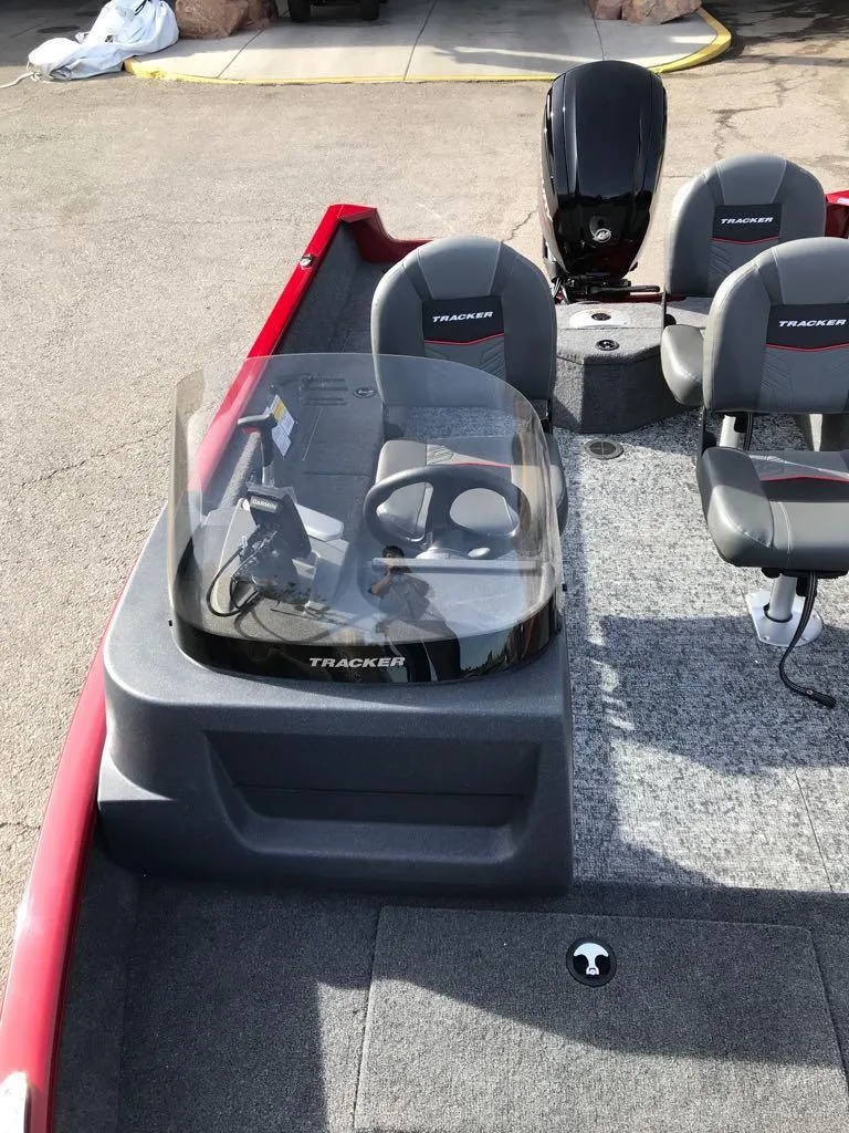 Slide: The Image of 2025 Tracker Pro Guide V-16 SC boat interior with steering console and seating. - 12