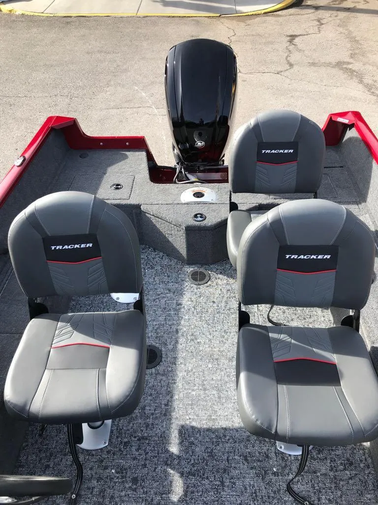 Slide: The Image of 2025 Tracker Pro Guide V-16 SC boat interior with three seats and motor. - 13