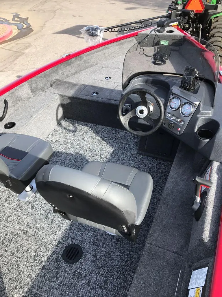 Slide: The Image of 2025 Tracker Pro Guide V-16 SC boat interior with steering console and seating. - 14