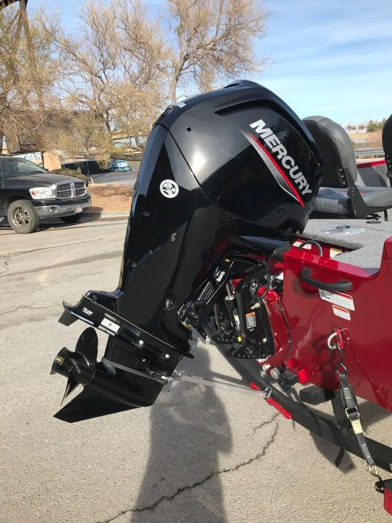 Slide: The Image of 2025 Tracker Pro Guide V-16 SC with Mercury outboard motor, parked outdoors. - 4