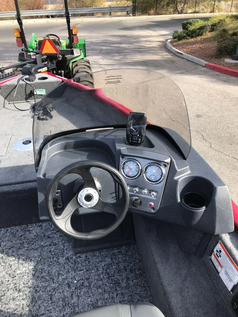 Slide: The Image of 2025 Tracker Pro Guide V-16 SC boat dashboard with steering wheel and gauges. - 7