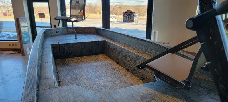 Slide: The Image of 2025 Tracker Grizzly 1650 T Prairie Wings Edition boat interior in showroom setting. - 11