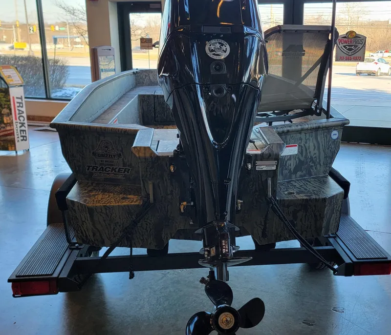 Slide: The Image of 2025 Tracker Grizzly 1650 T Prairie Wings Edition boat on display indoors. - 12