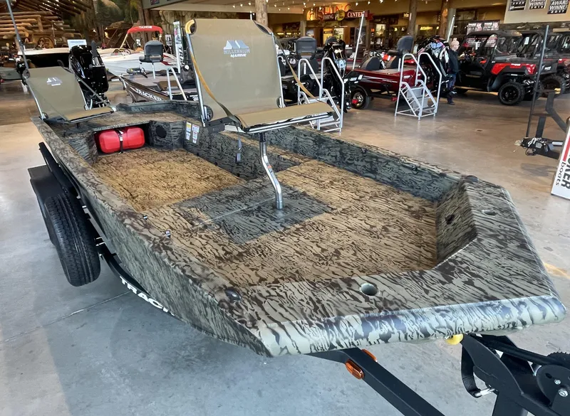 Slide: The Image of 2025 Tracker Grizzly 1650 T Prairie Wings Edition boat in showroom, camo design, with seating. - 13
