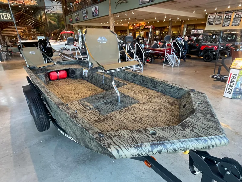 Slide: The Image of 2025 Tracker Grizzly 1650 T Prairie Wings Edition boat in showroom display. - 3