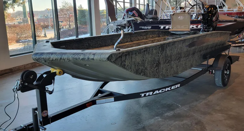 Slide: The Image of 2025 Tracker Grizzly 1650 T Prairie Wings Edition boat on trailer in showroom. - 5