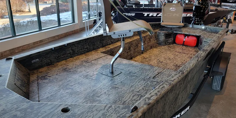 Slide: The Image of 2025 Tracker Grizzly 1650 T Prairie Wings Edition boat with camo design in showroom. - 6