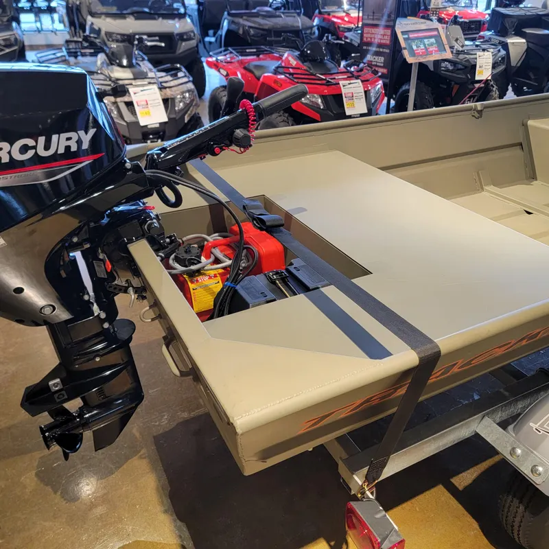 Slide: The Image of 2025 Tracker Grizzly 1542 Utility boat with Mercury outboard motor in showroom. - 2