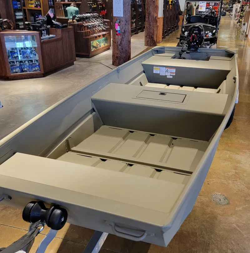 Slide: The Image of 2025 Tracker Grizzly 1542 Utility boat displayed in a showroom. - 3