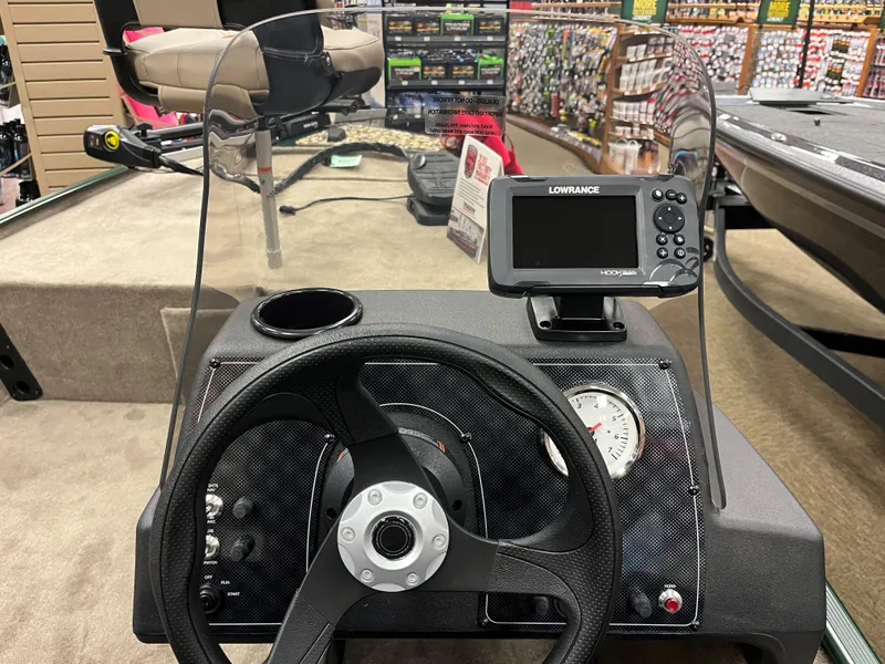 Slide: The Image of 2025 Tracker Bass Tracker Classic Limited dashboard with steering wheel and Lowrance fishfinder. - 11