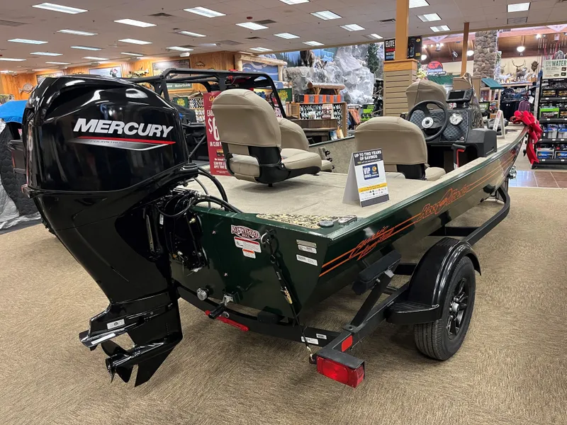 Slide: The Image of 2025 Tracker Bass Tracker Classic Limited boat with Mercury engine on display indoors. - 2