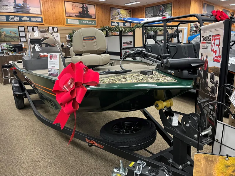 Slide: The Image of 2025 Tracker Bass Tracker Classic Limited boat with red bow in showroom. - 3