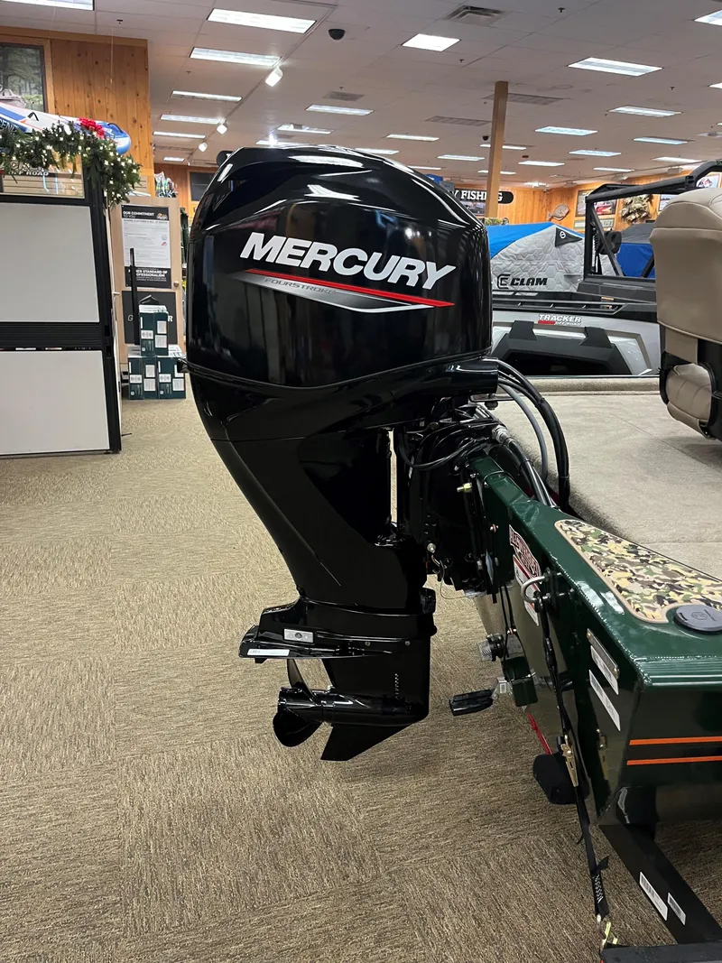 Slide: The Image of 2025 Tracker Bass Tracker Classic Limited with Mercury outboard motor in showroom. - 5