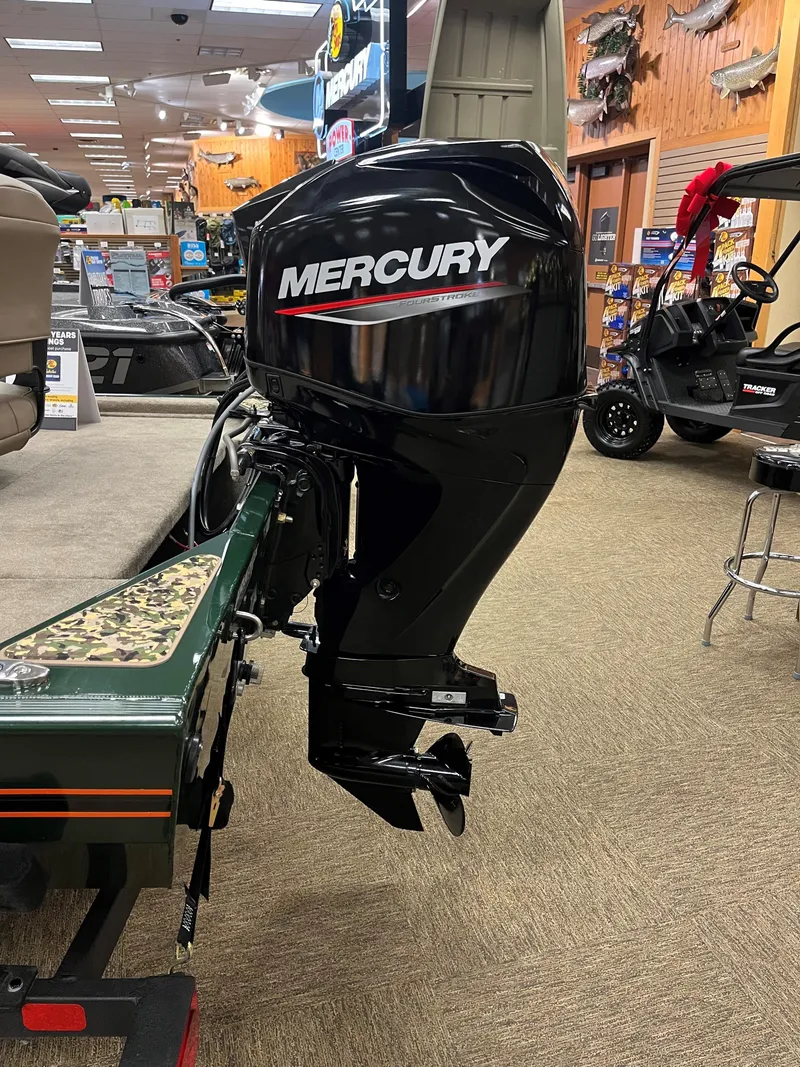Slide: The Image of 2025 Tracker Bass Tracker Classic Limited with Mercury outboard motor in showroom. - 6