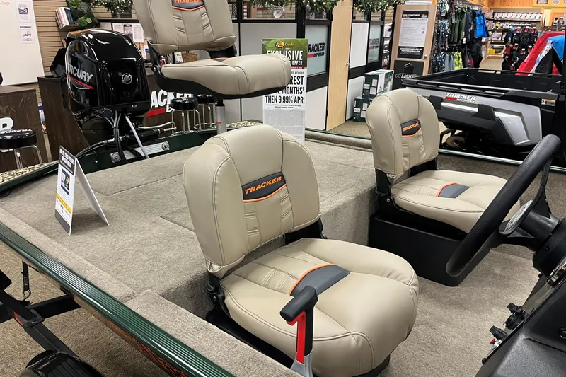 Slide: The Image of 2025 Tracker Bass Tracker Classic Limited boat interior with beige seats and Mercury motor. - 7