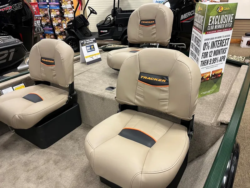 Slide: The Image of 2025 Tracker Bass Tracker Classic Limited boat seats in showroom with promotional signage. - 8