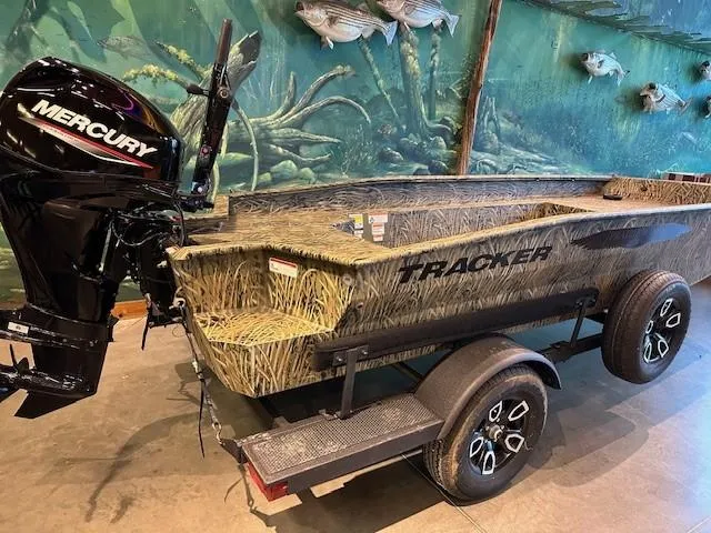 Slide: The Image of 2025 Tracker Grizzly 1650 T Prairie Wings Edition boat with Mercury engine, camo design. - 2