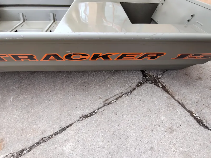 Slide: The Image of 2025 Tracker Grizzly 1542 Utility boat on concrete surface. - 2