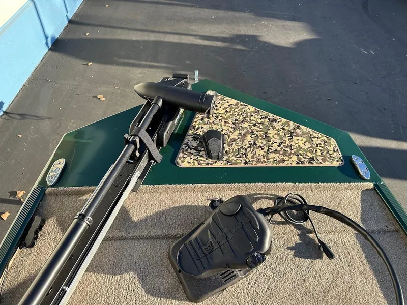 Slide: The Image of 2025 Tracker Bass Tracker Classic Limited boat deck with camouflage detail and equipment. - 21
